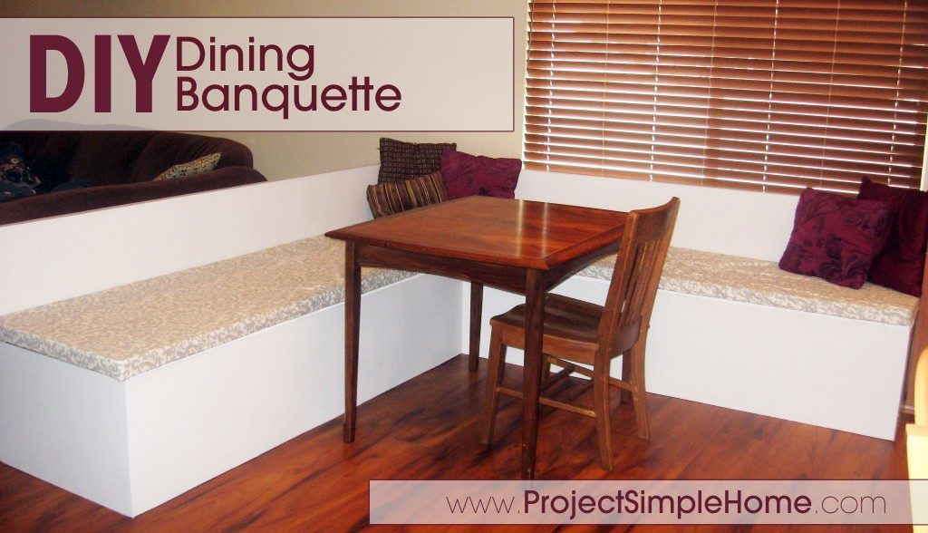 A finished white L-shaped dining banquette with a wood table